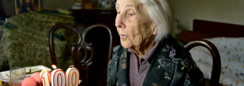 Woman blowing out a 100 birthday candle